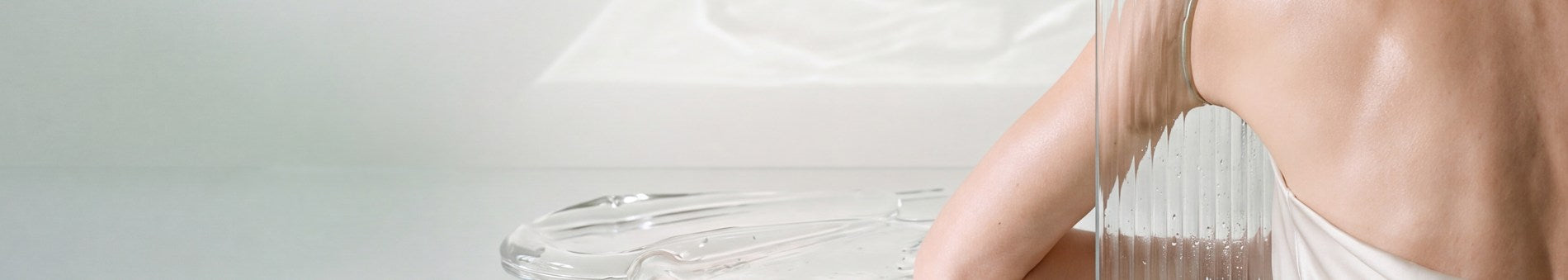 Clear glass resting on a luminous white surface.