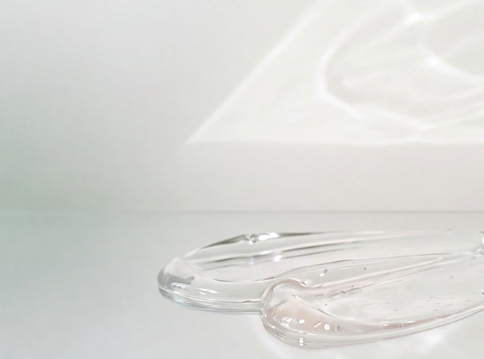 Clear glass dishes resting on a luminous white surface.